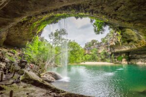 Hamilton Pool Preserve in Dripping Springs TX as shot from inside the cave. Hamilton Pool Preserve is one of the most famous Texas waterfalls.
