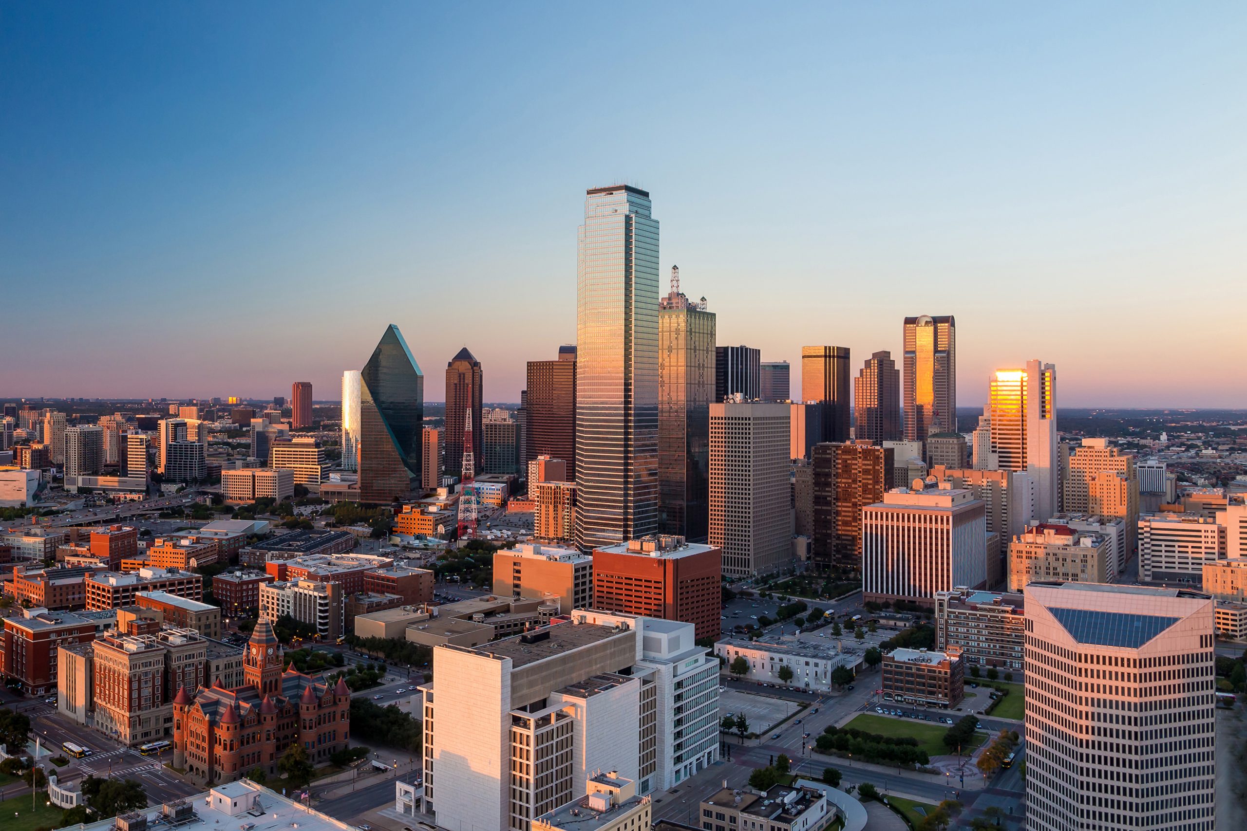 Dallas skyline as seen from Reunion Tower at sunset. Dallas is one of the most romantic getaways in Texas for couples