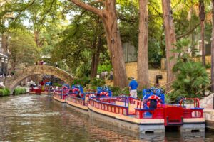 Colorful tourist boats parked along the Riverwalk in San Antonio. The Riverwalk is one of the most instagrammable places in San Antonio