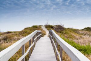 Long stretch of boardwalk leading to the beach in Port Aransas Texas