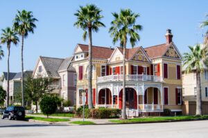 Yellow house situated on a corner in the East End Historic District. Strolling by these Victorian homes is one of the best things to do in Galveston TX