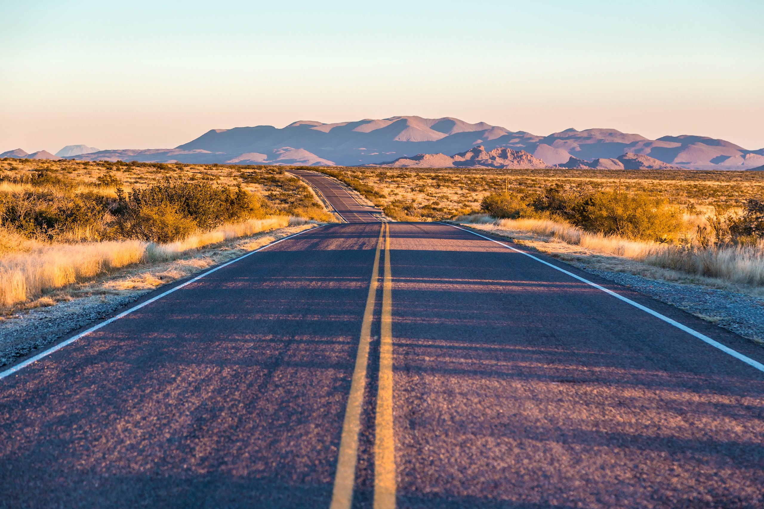 open road in west texas near sunset. some of the best weekend getaways from san antonio tx are in west tx