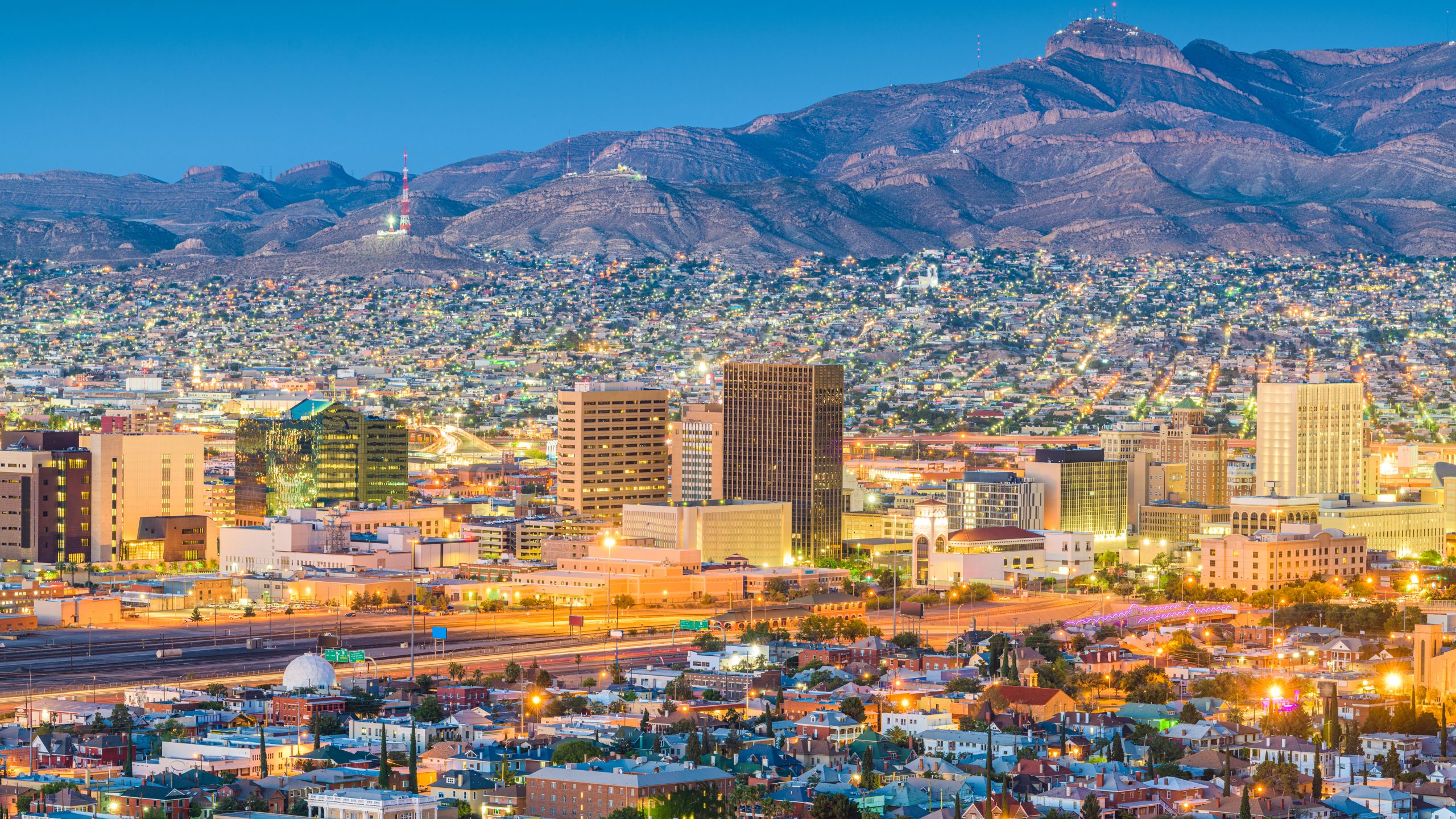 skyline of el paso at night with mountains in the background. there are lots of fun things to do in el paso tx