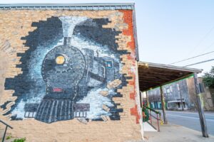 mural of an old fashioned train painted on a brick wall in dublin tx, one of the best day trips from fort worth texas