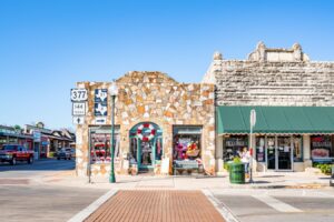 downtown granbury tx with two stone buildings as seen from across the street