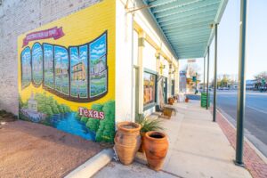 mural in boerne texas, painted on the side of a brick building. exploring downtown is one of the best things to do in boerne tx