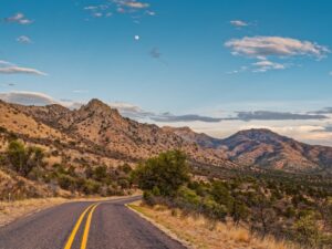 road through fort davis mountains state park texas with mountains in the background