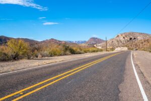 two lane road in west texas, as seen when driving from austin to big bend national park road trip