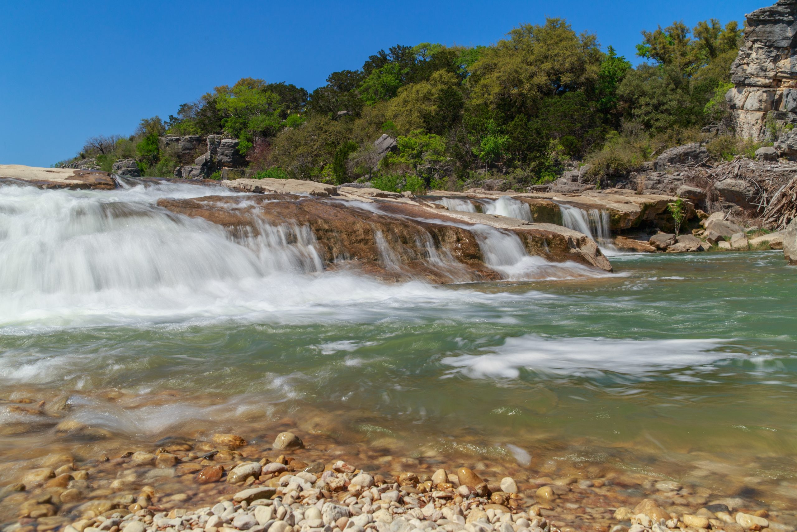 small waterfall in pedernales falls state park, one of the best state parks in texas