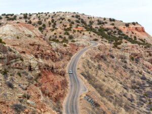 aerial view of scenic road in palo duro canyon, one of the best day trips from amarillo tx