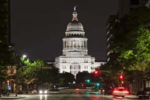 view of texas state capitol building from congress street at night, one of the most haunted places in austin tx
