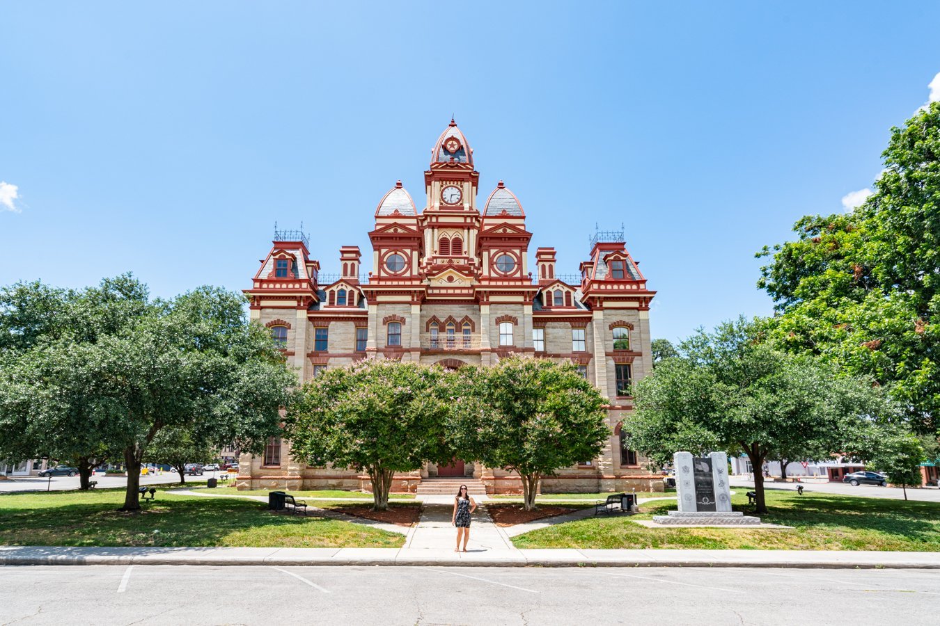 kate storm standing in front of caldwell county courthouse, one of the best things to do in lockhart texas