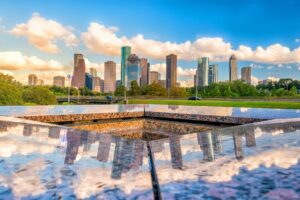 downtown houston skyline as seen from across a reflecting pool, best quotes about houston sayings